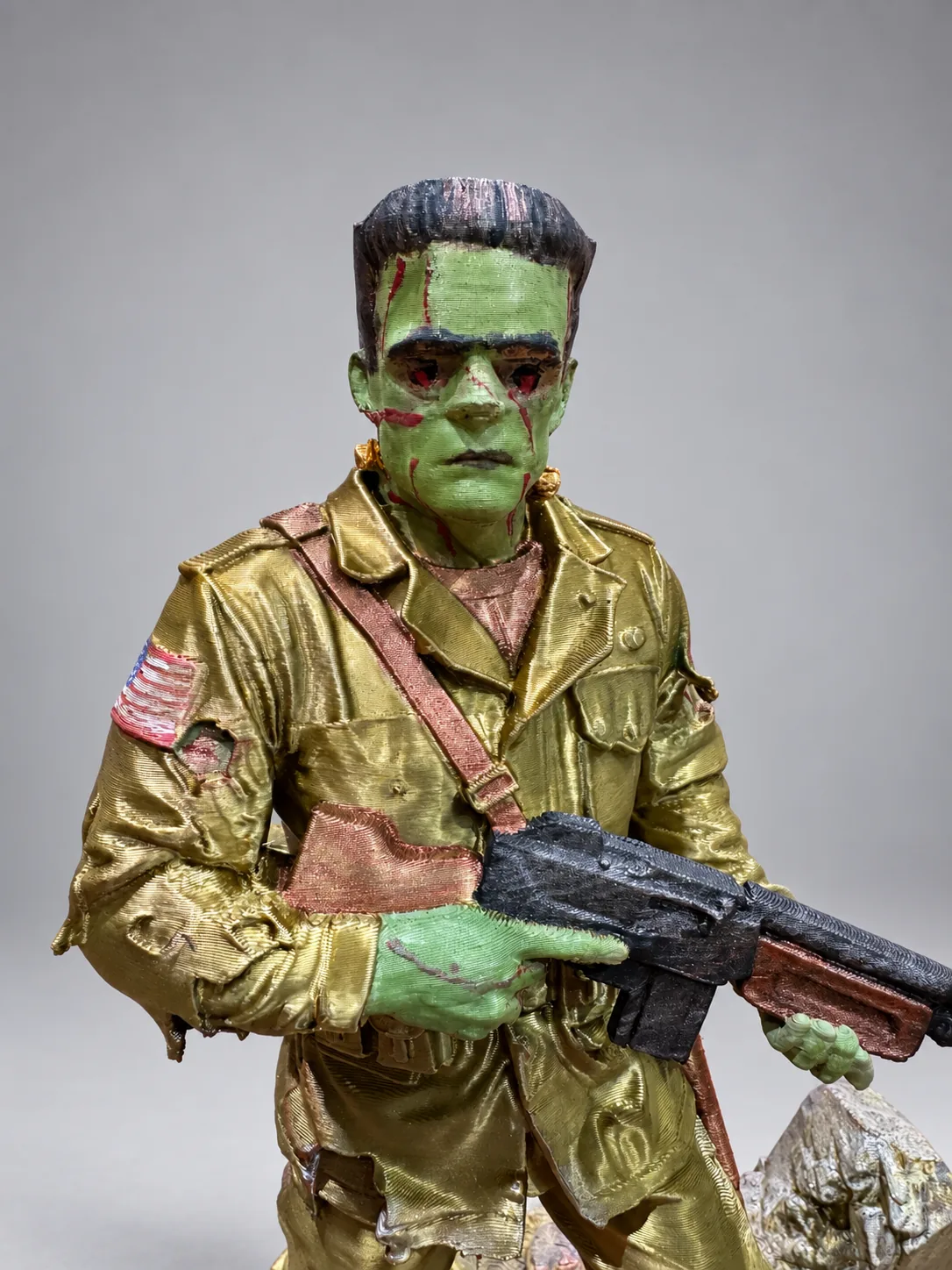 Studio close-up of green Frankenstein-inspired face and torn WWII uniform